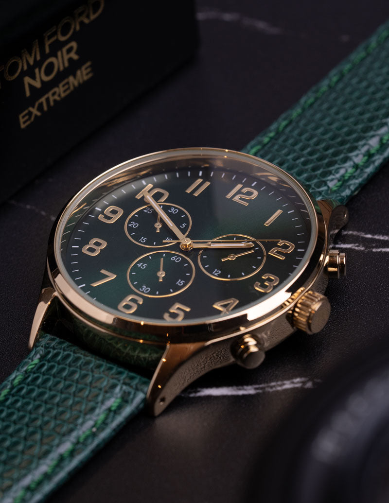 A close image of a non branded watch with a genuine green lizard watch strap.