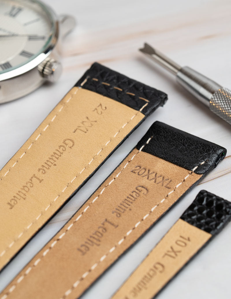 A close up image of a range of extra long watch straps showing the variations of length.
