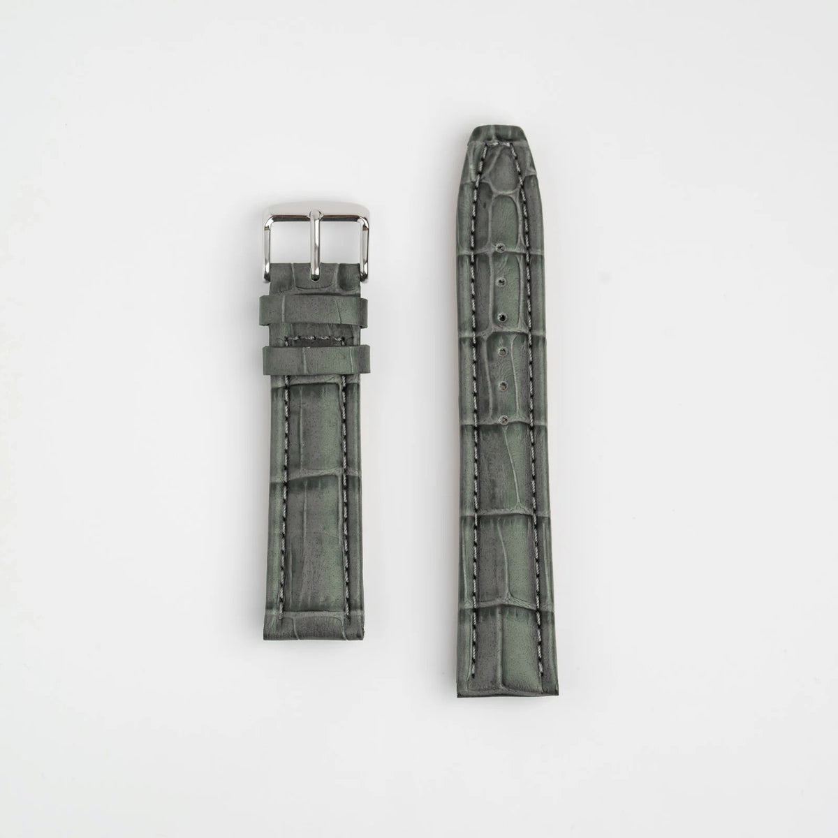 Grey padded alligator grain leather watch strap, laid flat with buckle