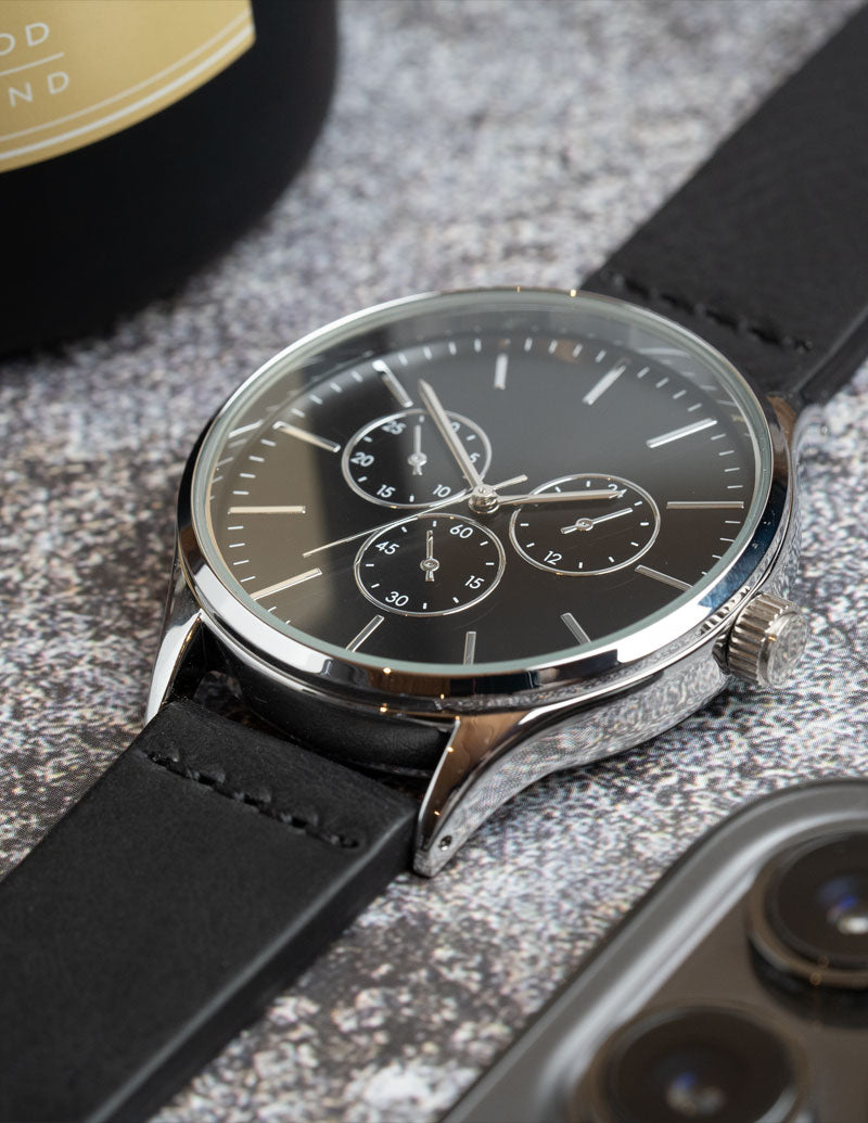 A close up image of a non branded watch with fitted to a handmade leather watch strap.