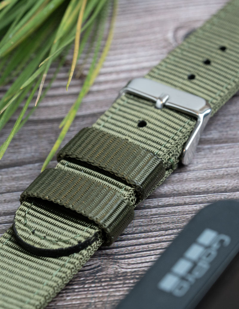 A close up image of a green nylon watch strap.