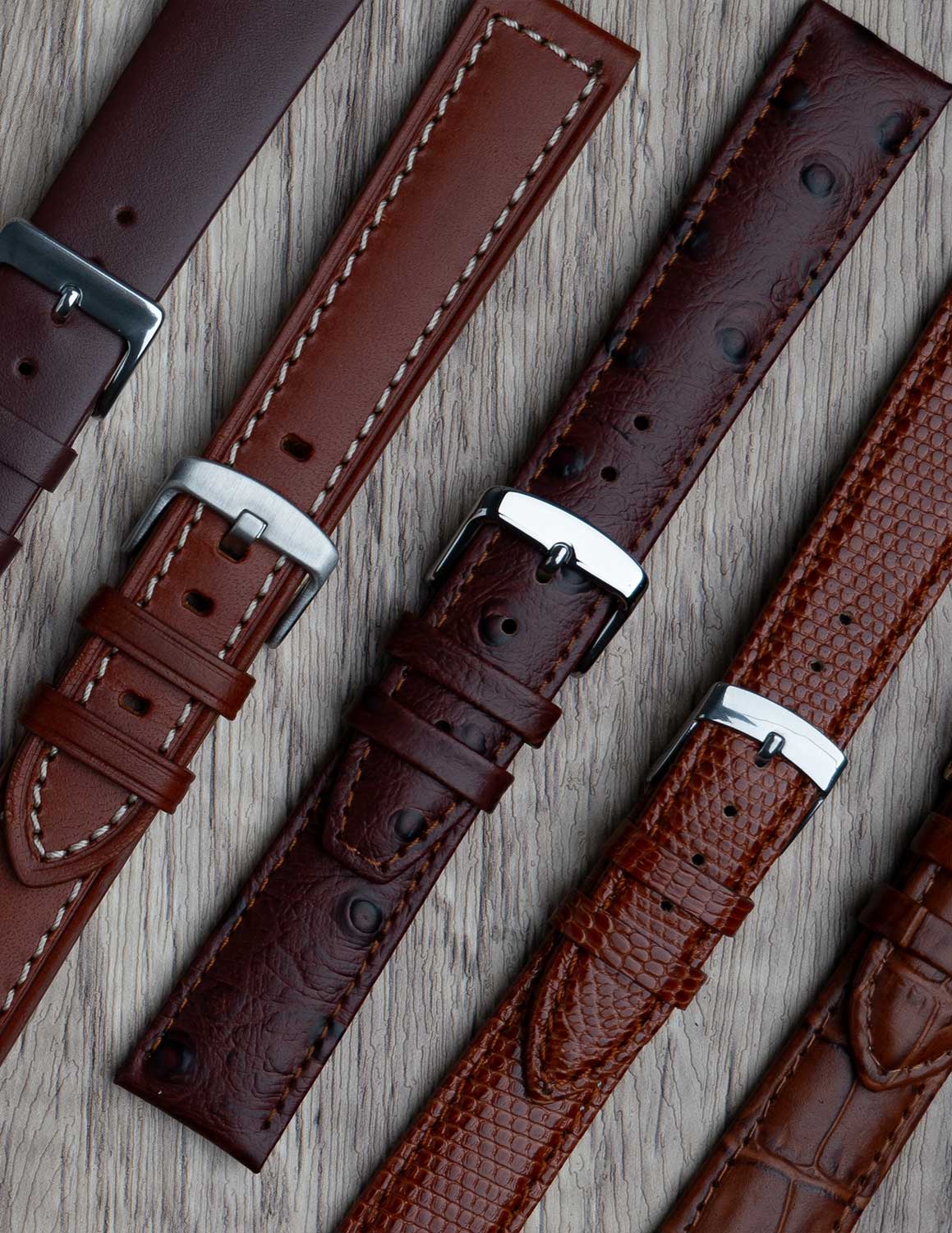A selection of brown watch straps showing the different grains of leather and styles.