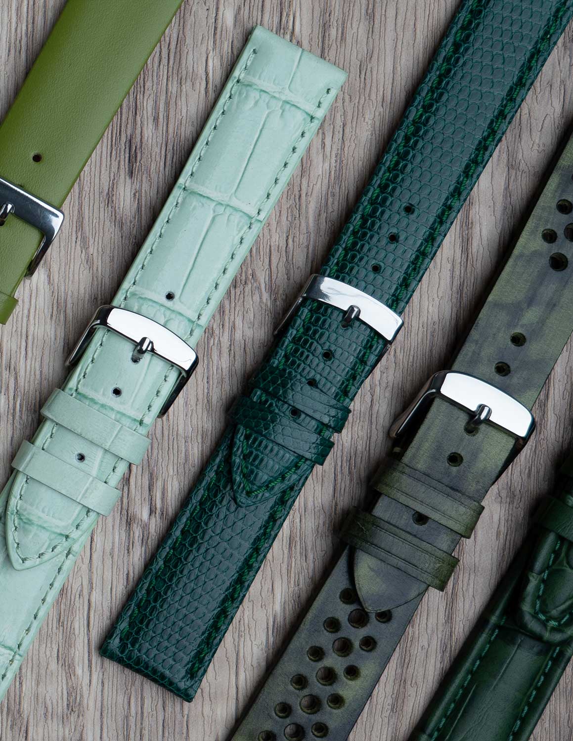 A selection of green watch straps showing the different grains of leather and styles.