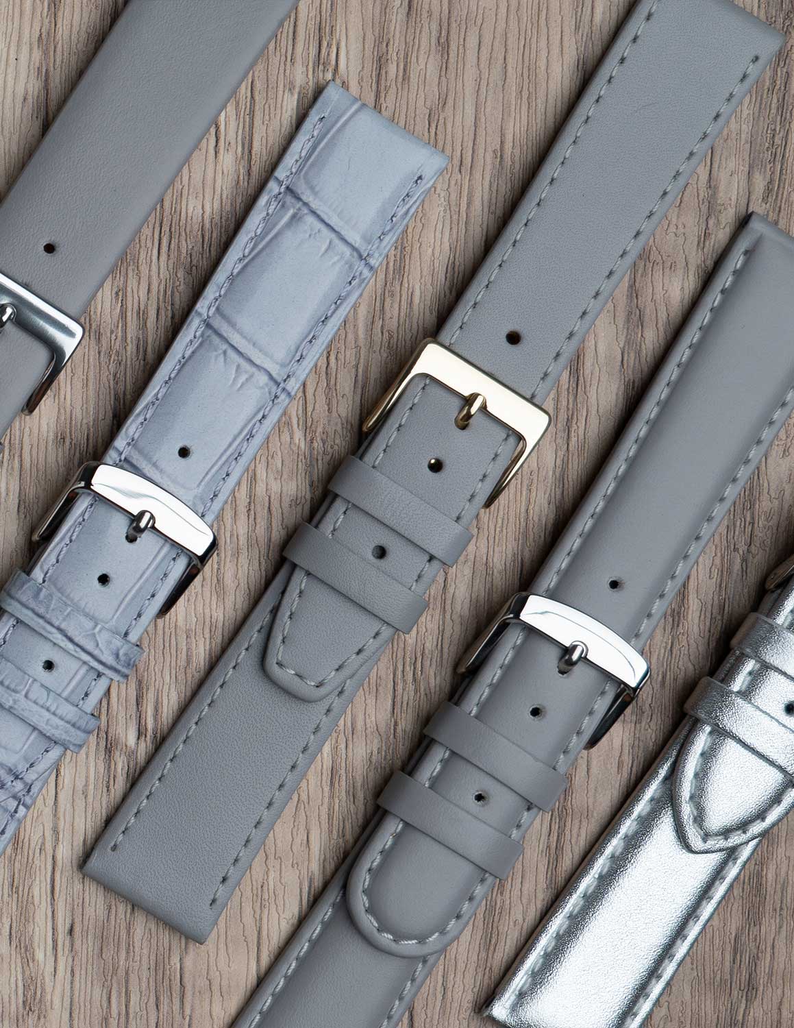 A selection of grey watch straps showing the different grains of leather and styles.
