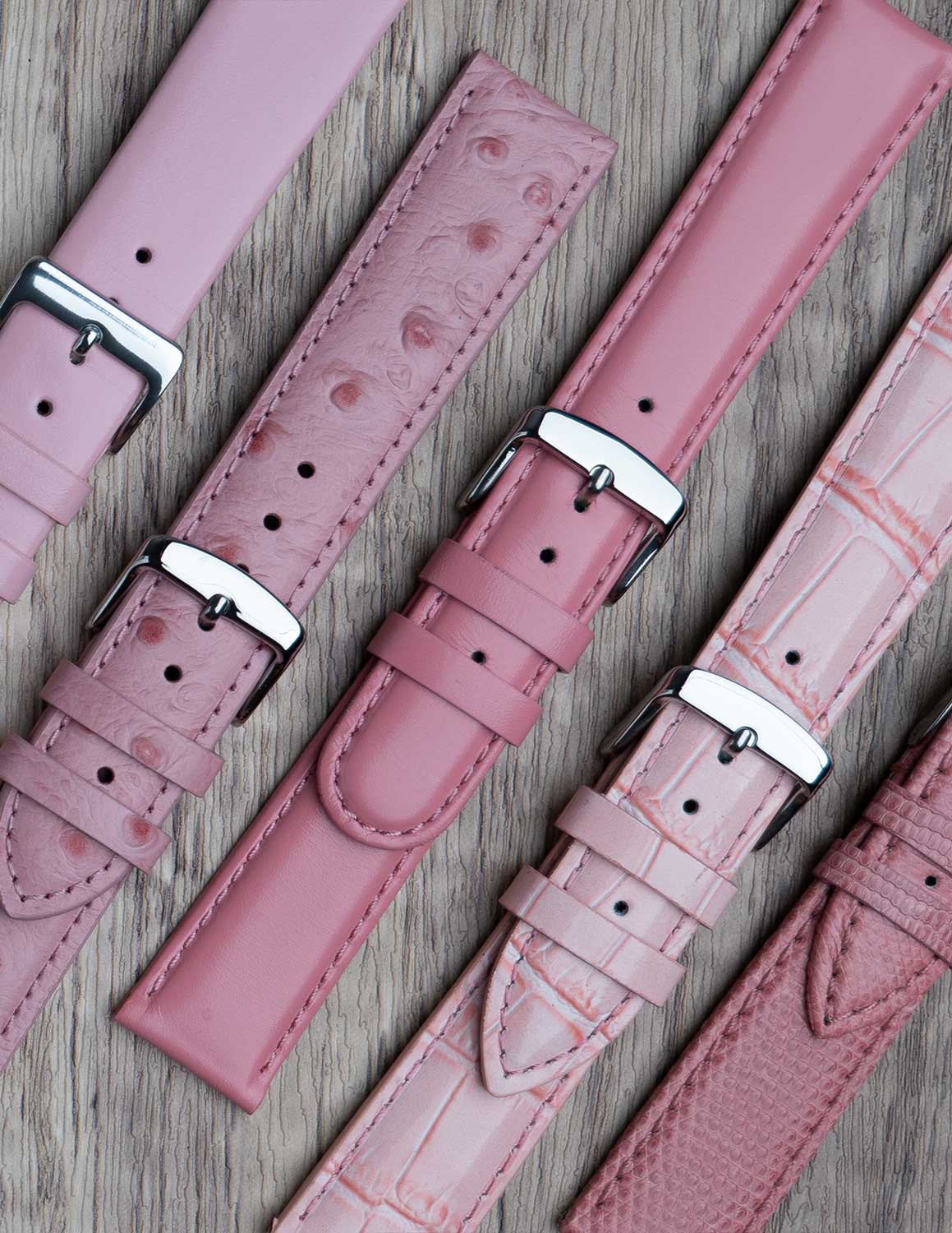 A selection of pink watch straps showing the different grains of leather and styles.