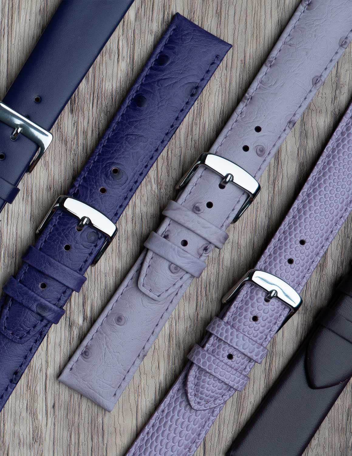 A selection of purple watch straps showing the different grains of leather and styles.