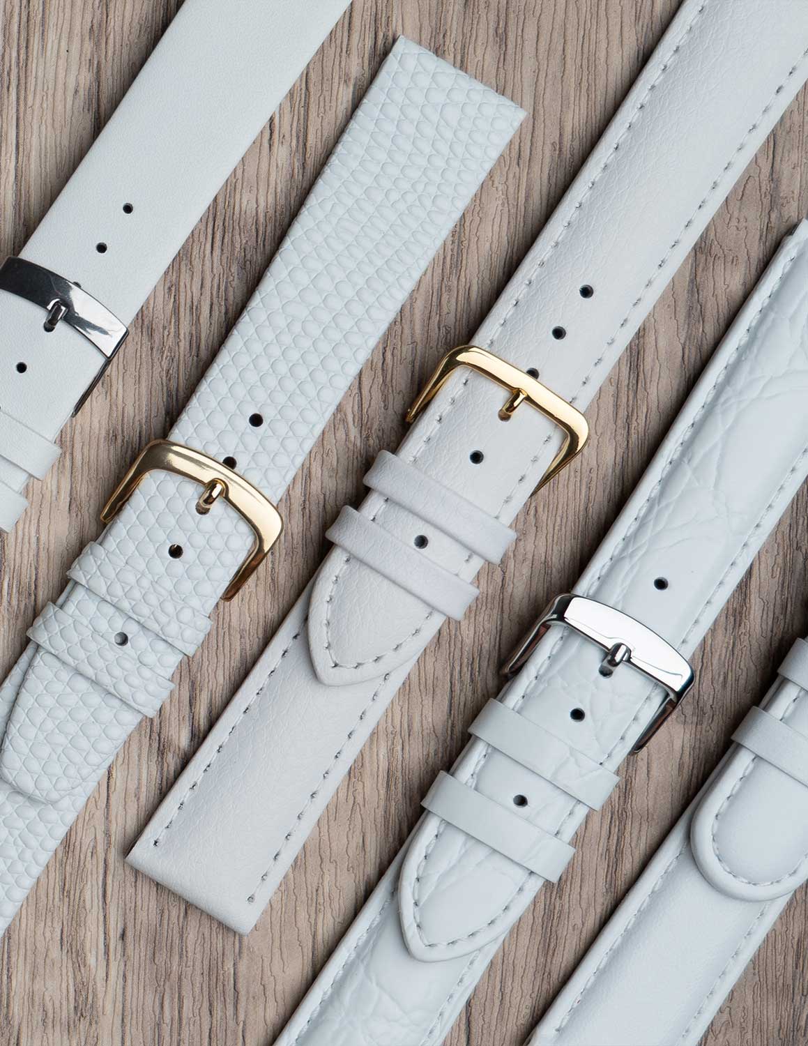 A selection of white watch straps showing the different grains of leather and styles.