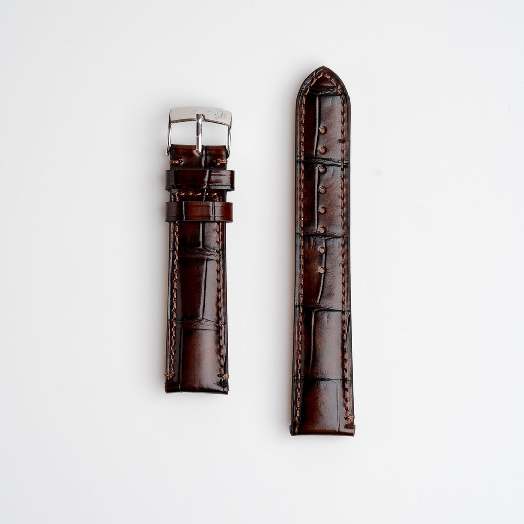 Morellato tiepolo brown alligator grain leather watch strap with a silver buckle, displayed flat on a white background.
