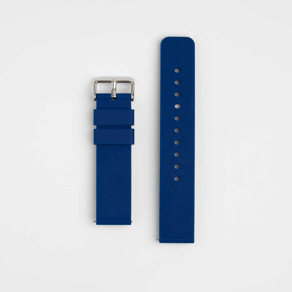 A navy blue silicone watch strap with a silver buckle laid out flat on a white background.