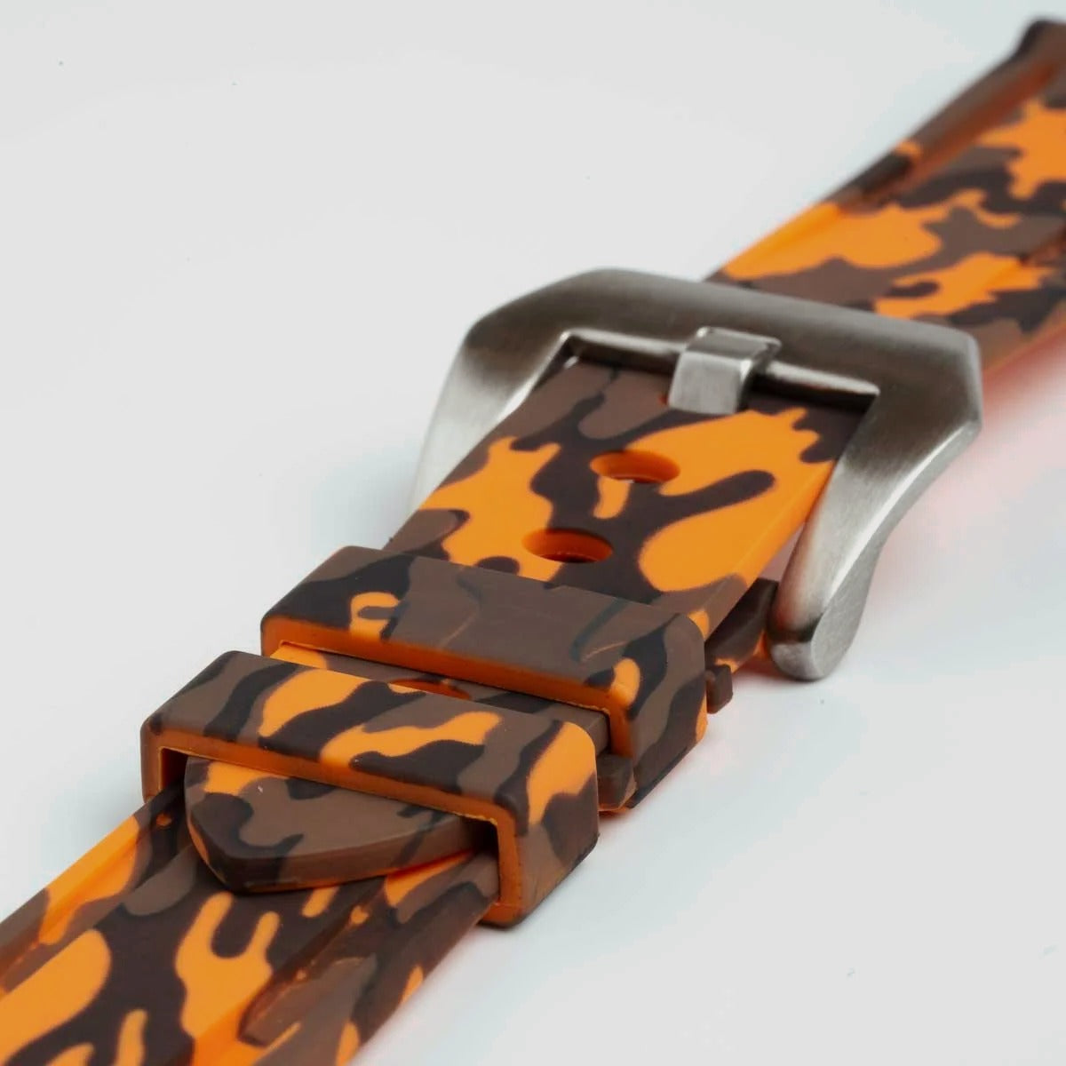 Close-up of the orange camo strap's buckle and keepers