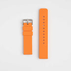 An orange silicone watch strap with a silver buckle and pin, displayed flat on a white background.