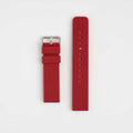 A red silicone watch strap with a silver buckle and quick release mechanism, displayed flat on a white background.