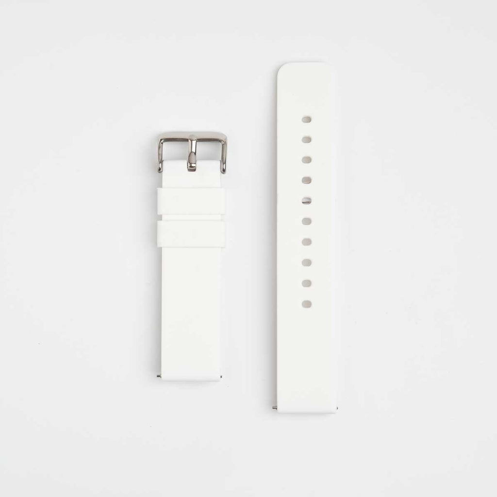 A white silicone watch strap with a silver buckle on a light background.
